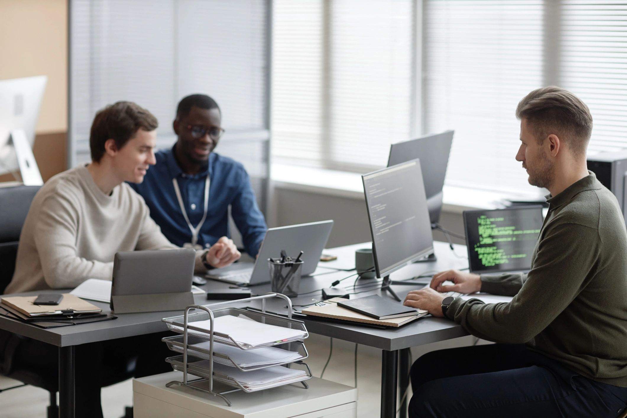 Technology team collaborating in a modern software development office