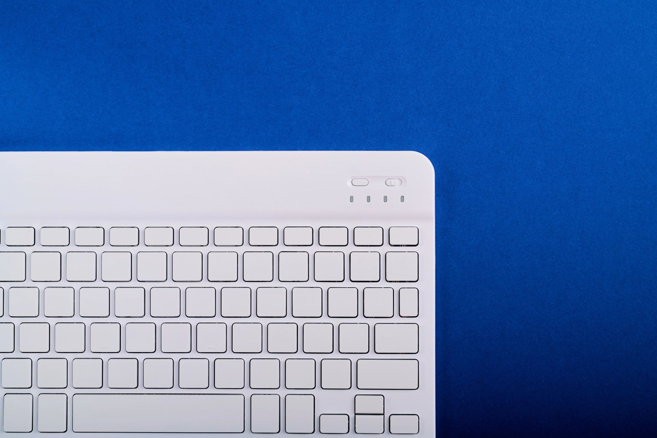 Modern business communication workspace with keyboard on blue desk